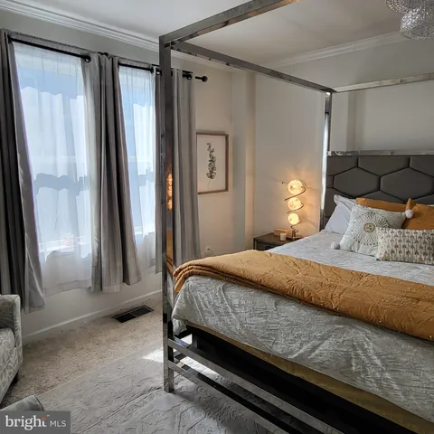 a bedroom with a bed and a window