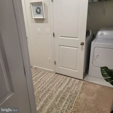 a view of a storage & utility room with a washer dryer