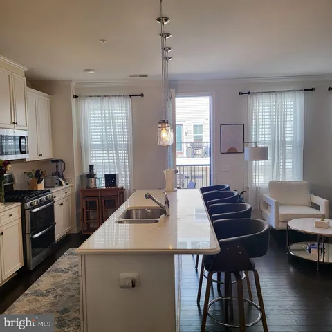 a kitchen that has a sink and a stove in it