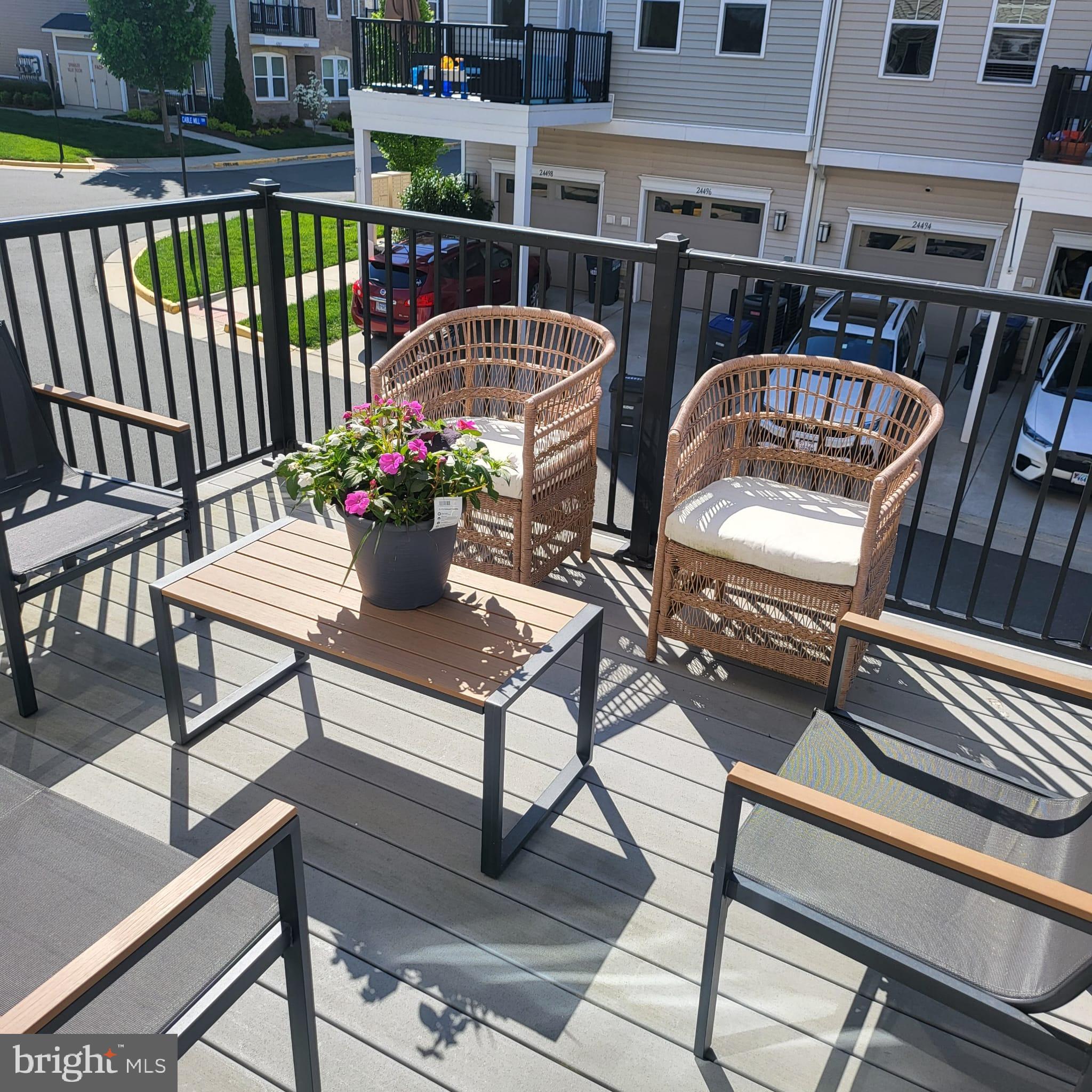 24626 Cable Mill Terrace Aldie, VA 20105 - Photo 42 of 46 a view of balcony with wooden floor and outdoor seating