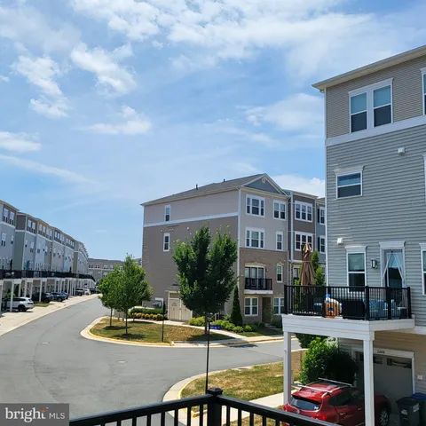 a view of a balcony with chairs and wooden fence