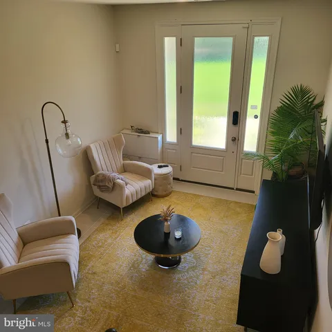 a living room with furniture and a rug