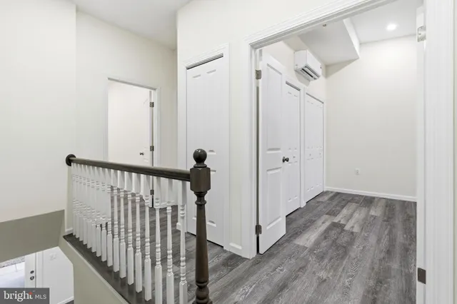 a view of a hallway with wooden floor and entryway