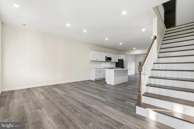 a view of kitchen with sink and refrigerator