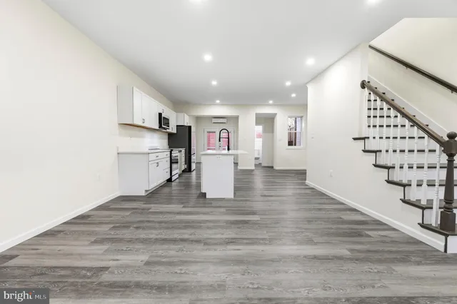 a view of kitchen with furniture and wooden floor