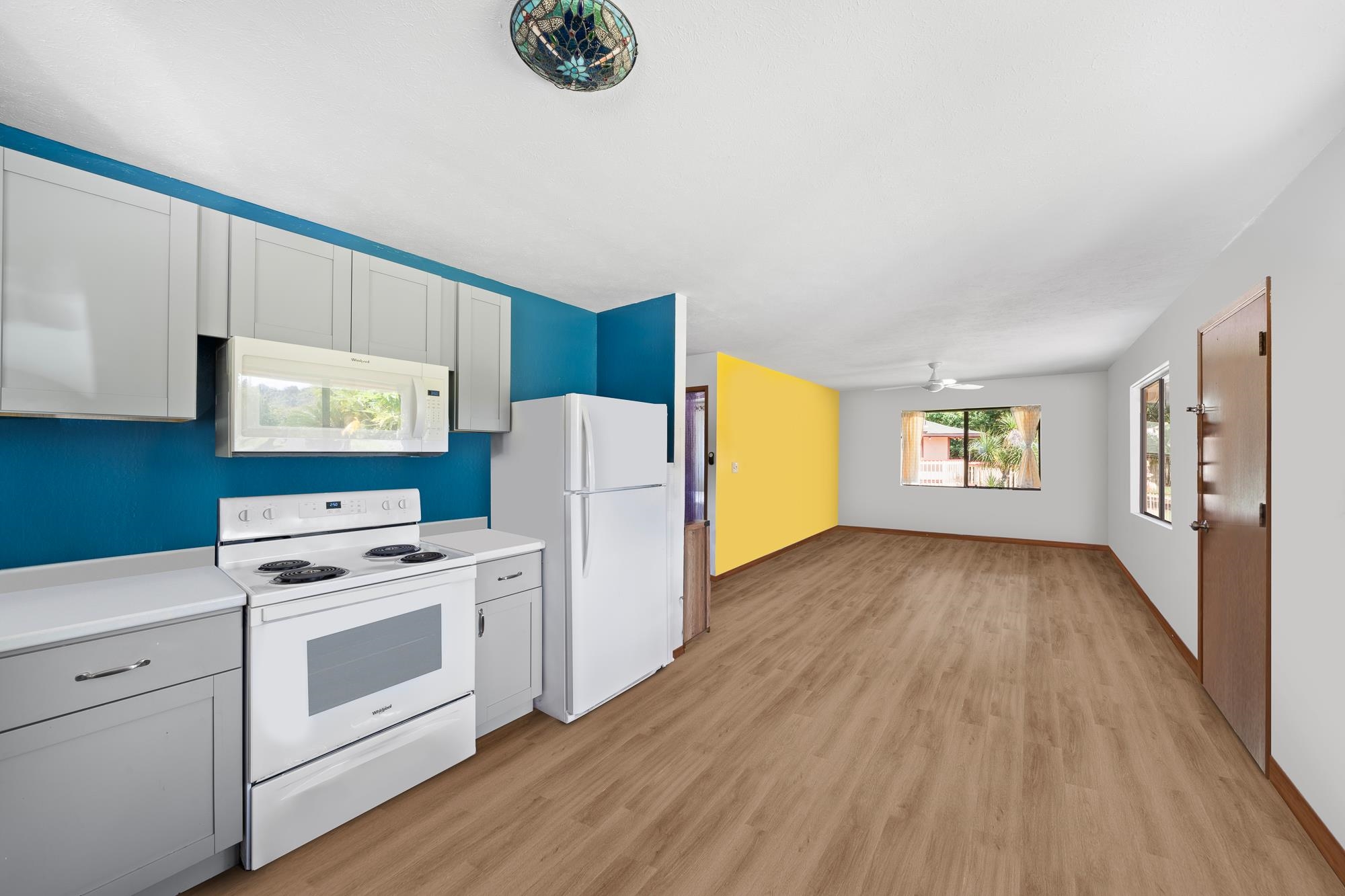 2215 Apala Place Haiku, HI 96708 - Photo 8 of 40 a kitchen with a refrigerator a stove and wooden floor