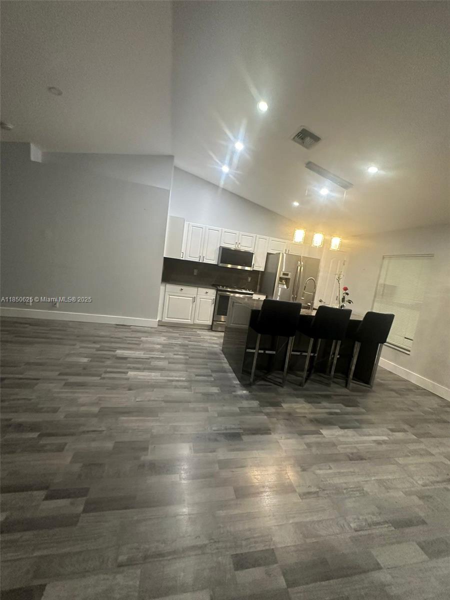 442 Conlee Street Lehigh Acres, FL 33974 - Photo 21 of 79 a room with lots of chairs and mirrors