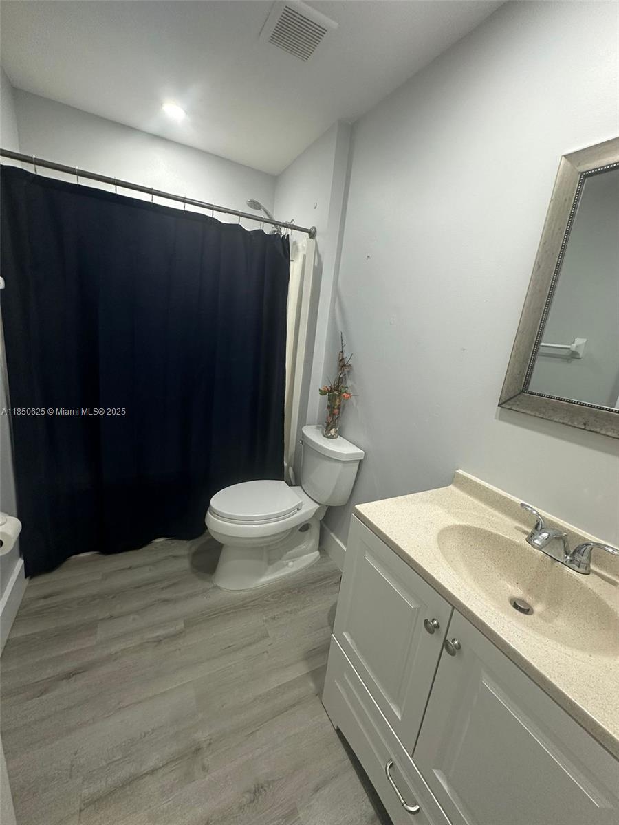 442 Conlee Street Lehigh Acres, FL 33974 - Photo 23 of 79 a bathroom with a sink a toilet a mirror and shower