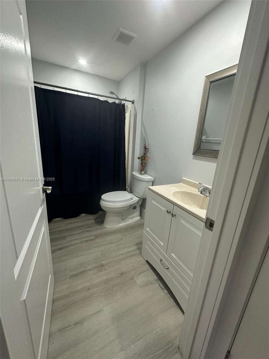 442 Conlee Street Lehigh Acres, FL 33974 - Photo 24 of 79 a bathroom with a sink toilet and shower