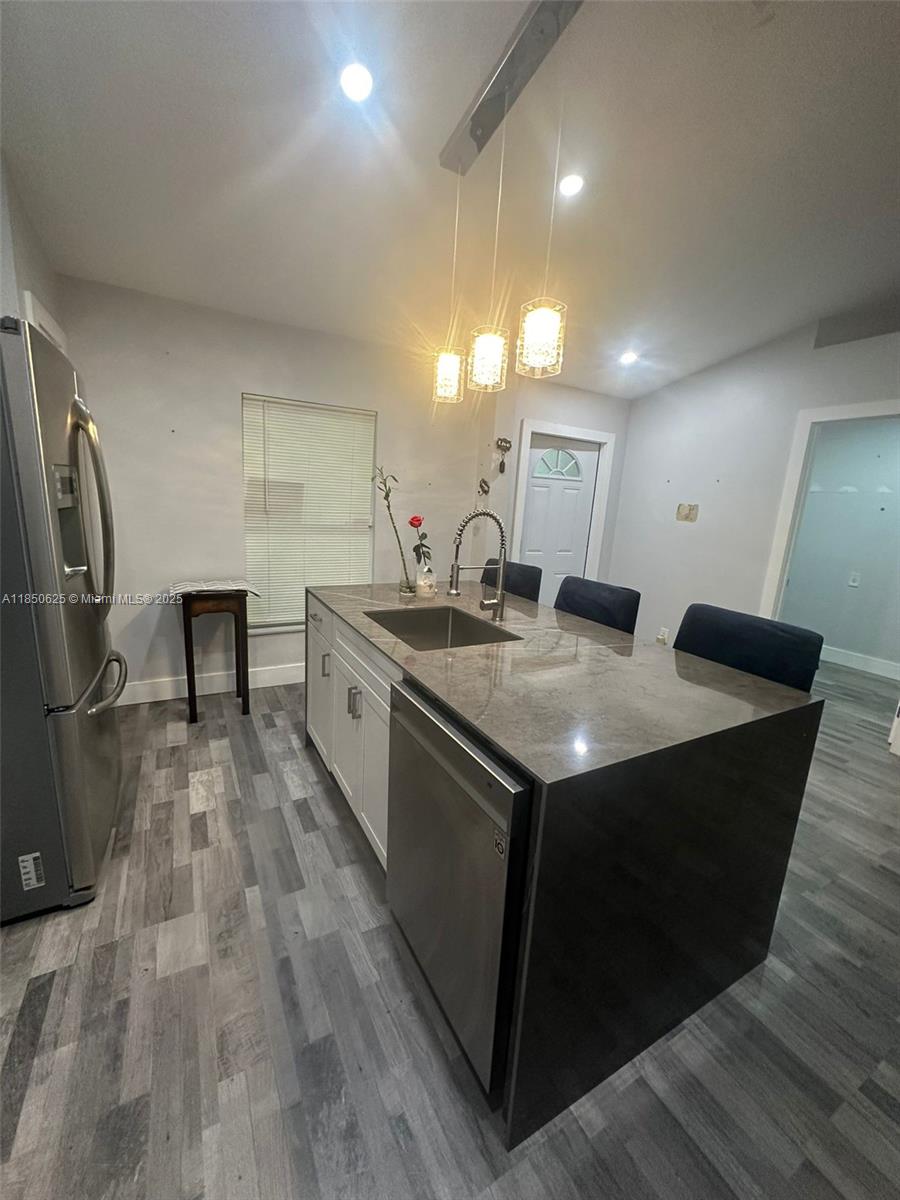 442 Conlee Street Lehigh Acres, FL 33974 - Photo 27 of 79 a kitchen with a stove and a sink