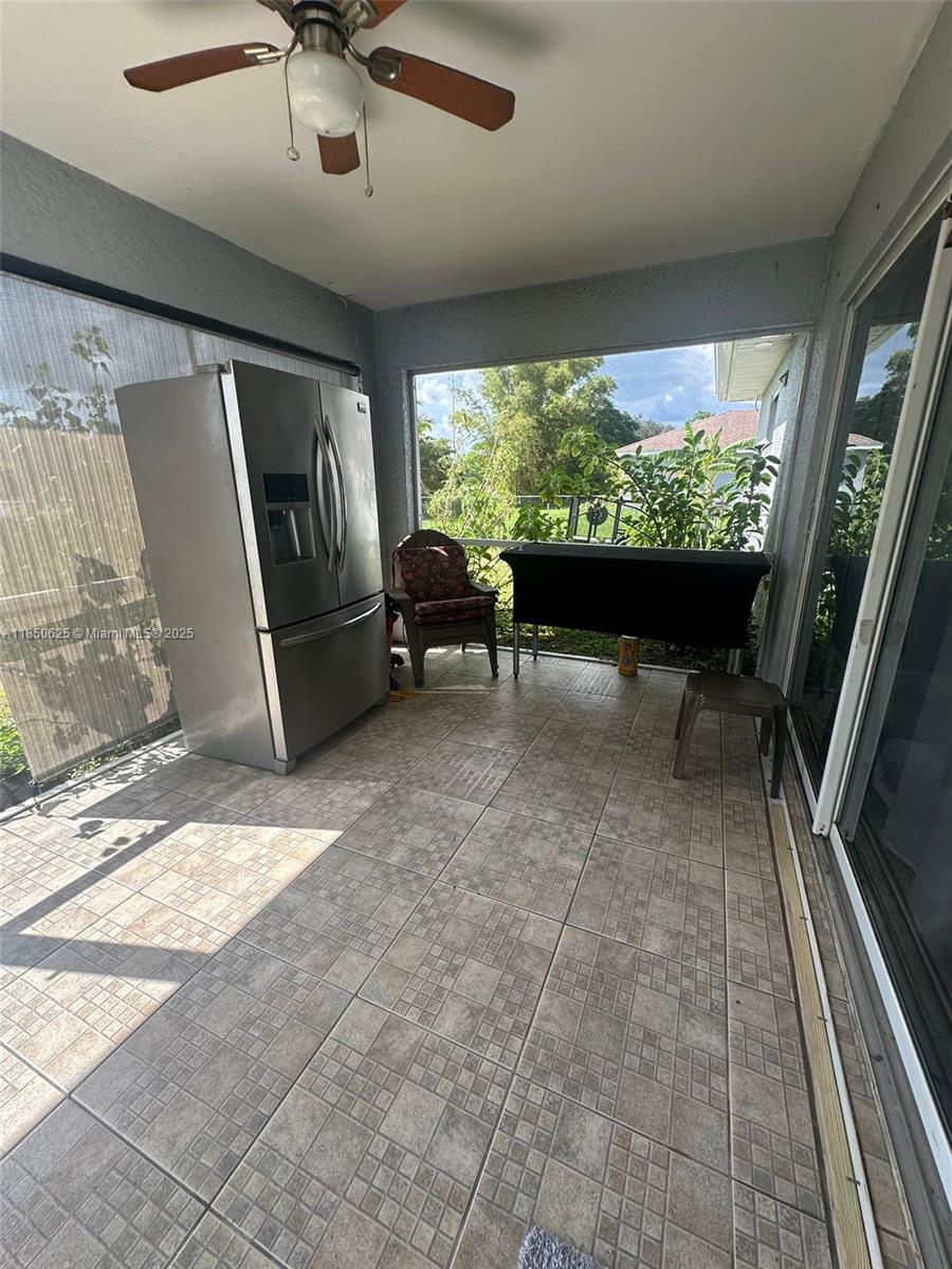 442 Conlee Street Lehigh Acres, FL 33974 - Photo 37 of 79 a living room with furniture and a large window