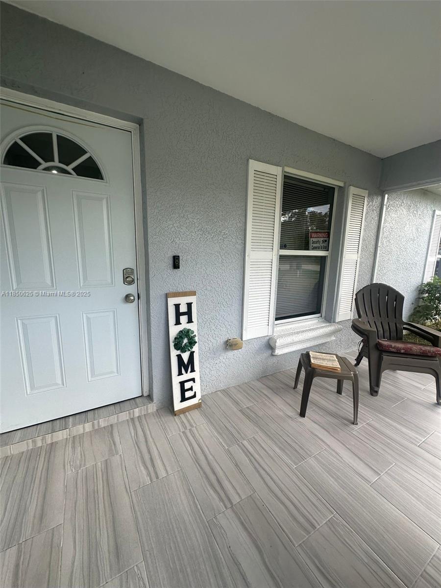 442 Conlee Street Lehigh Acres, FL 33974 - Photo 42 of 79 a living room with furniture and a wooden floor