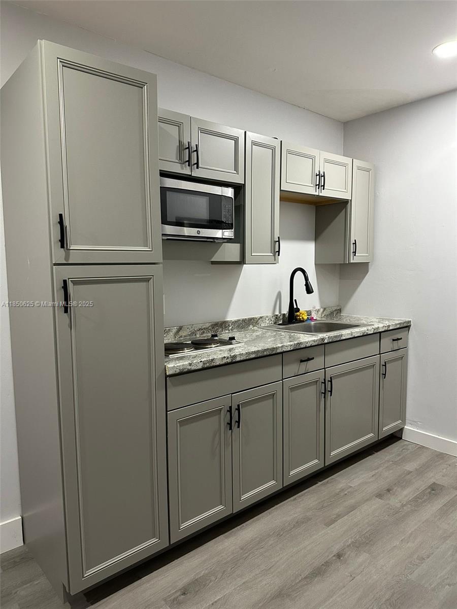 442 Conlee Street Lehigh Acres, FL 33974 - Photo 49 of 79 a kitchen with stainless steel appliances a sink and cabinets