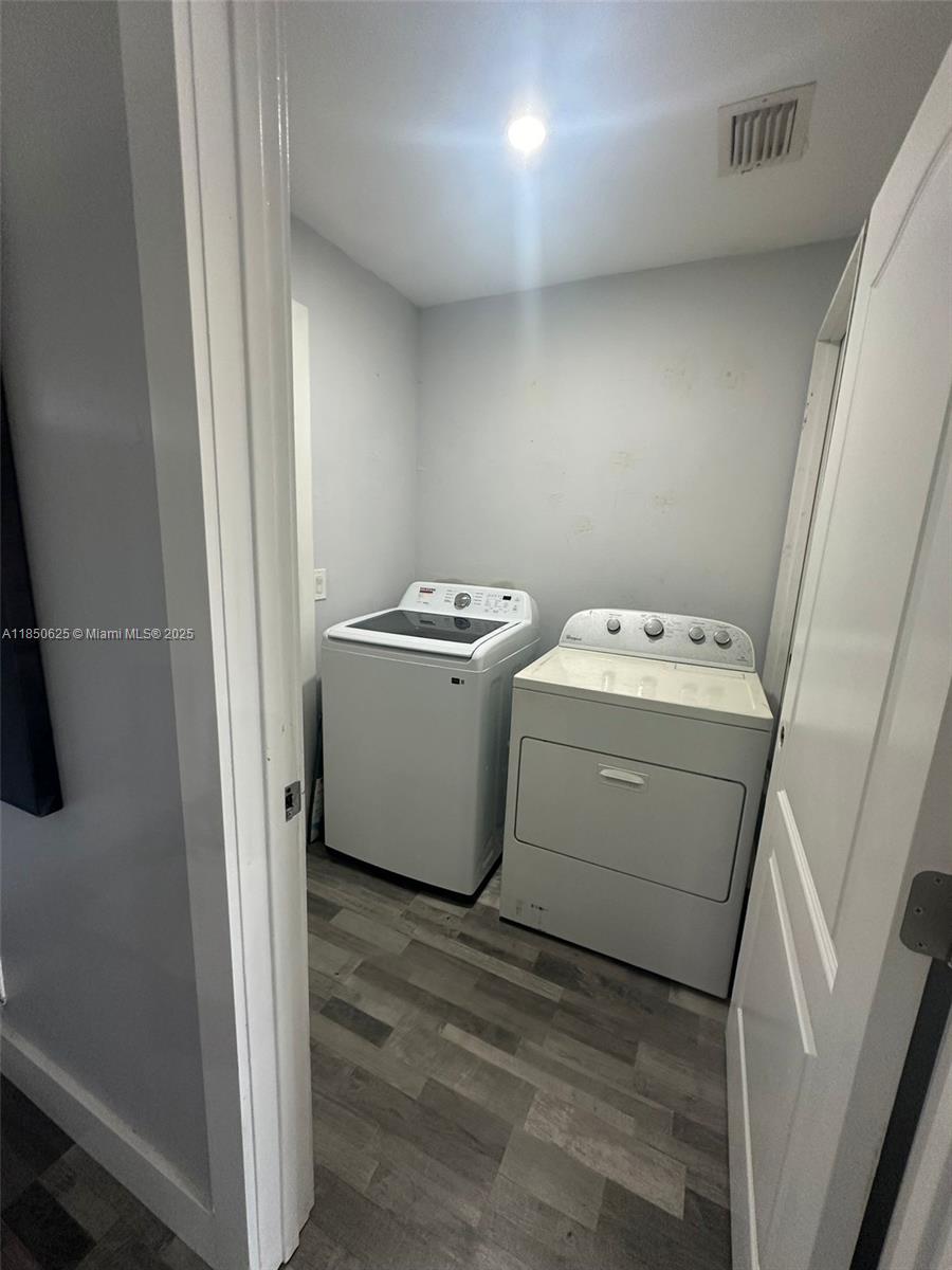 442 Conlee Street Lehigh Acres, FL 33974 - Photo 52 of 79 a utility room with dryer and washer