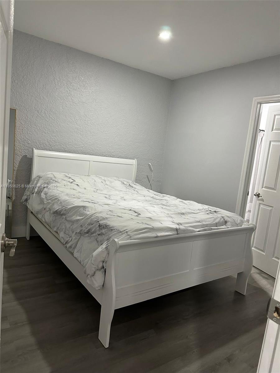 442 Conlee Street Lehigh Acres, FL 33974 - Photo 54 of 79 a bed sitting in a bedroom next to a window