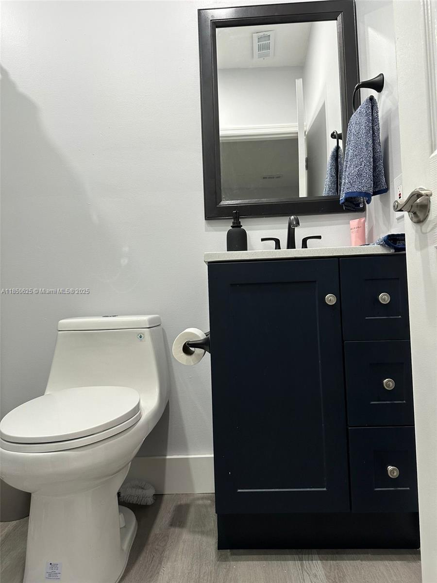 442 Conlee Street Lehigh Acres, FL 33974 - Photo 57 of 79 a bathroom with a toilet sink and mirror