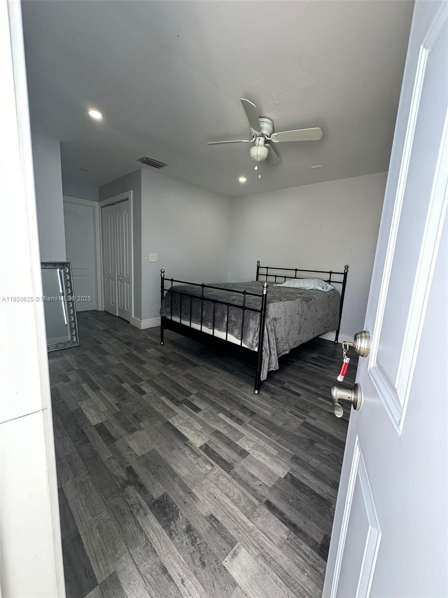 442 Conlee Street Lehigh Acres, FL 33974 - Photo 61 of 79 a view of livingroom with hardwood floor and ceiling fan