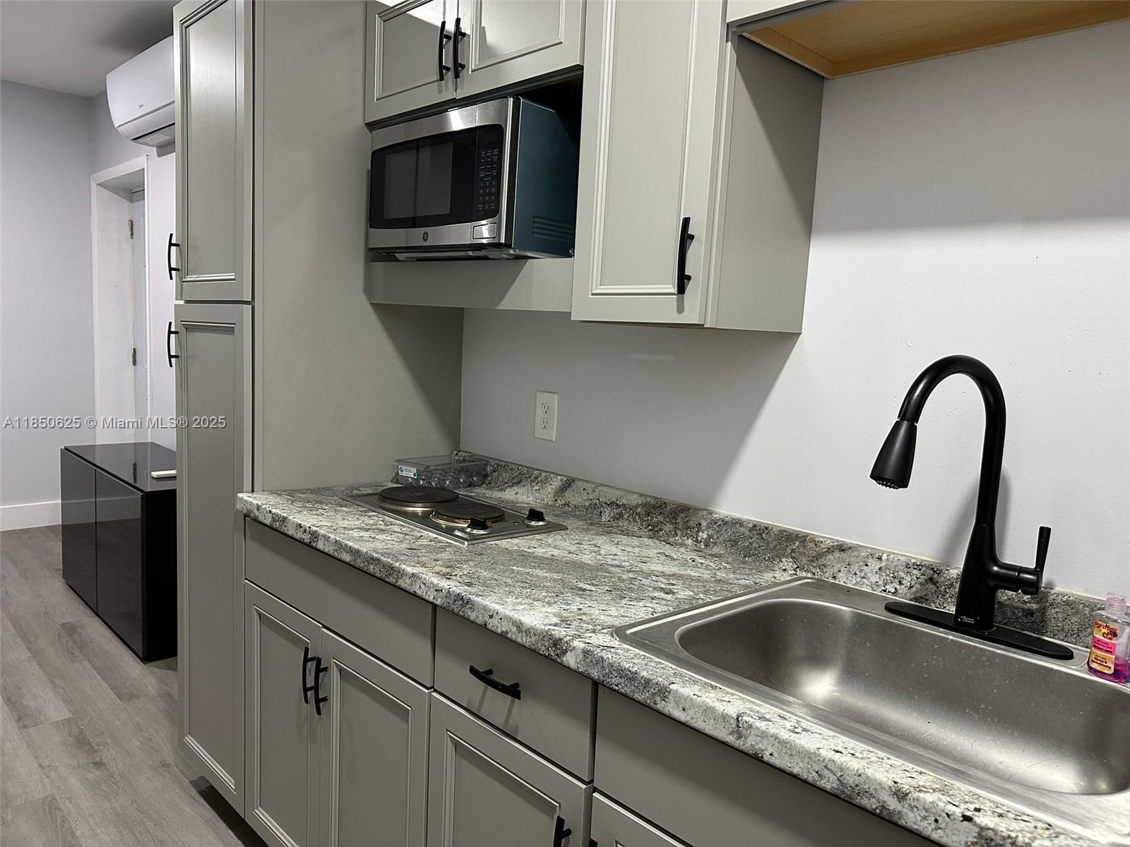 442 Conlee Street Lehigh Acres, FL 33974 - Photo 62 of 79 a kitchen with a sink and a stove top oven