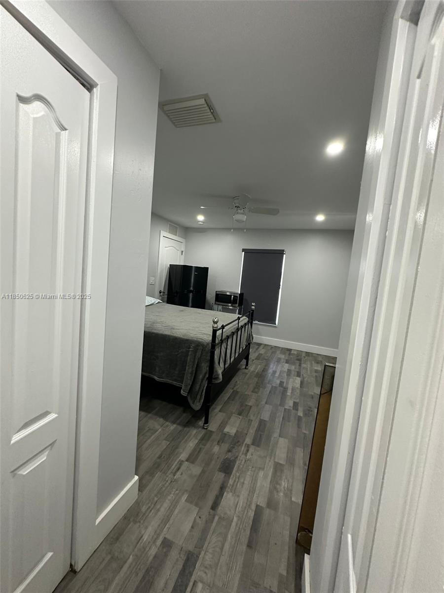 442 Conlee Street Lehigh Acres, FL 33974 - Photo 63 of 79 a living room with furniture and a wooden floor