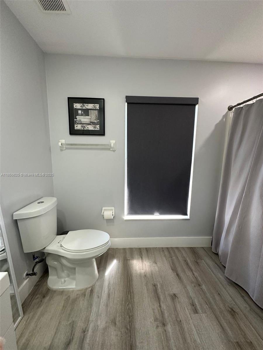 442 Conlee Street Lehigh Acres, FL 33974 - Photo 64 of 79 a bathroom with a toilet and a shower