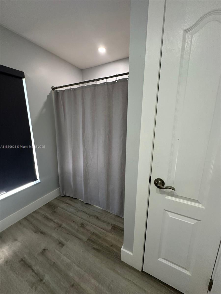 442 Conlee Street Lehigh Acres, FL 33974 - Photo 67 of 79 a view of an empty room with wooden floor and a window