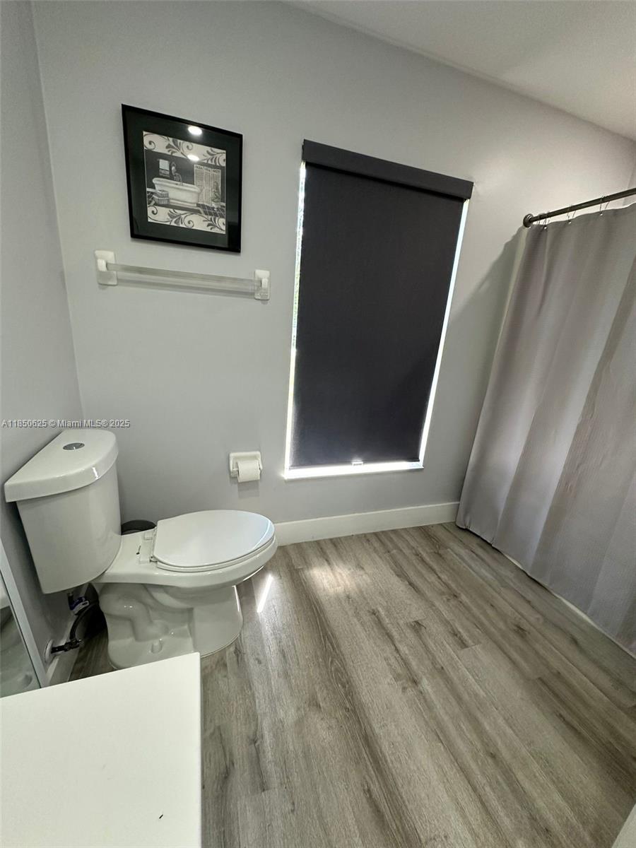 442 Conlee Street Lehigh Acres, FL 33974 - Photo 68 of 79 a bathroom with a toilet a sink and mirror