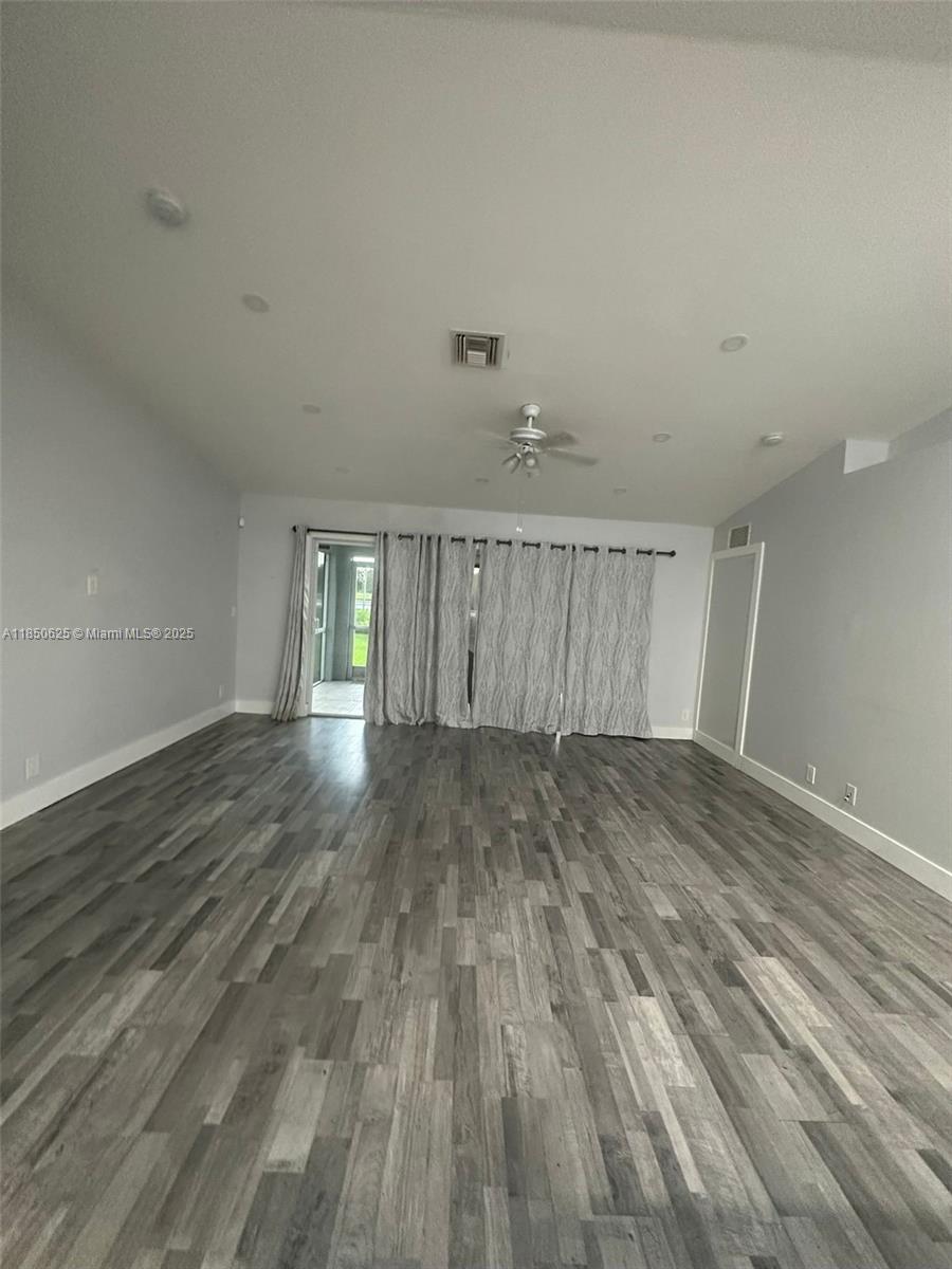 442 Conlee Street Lehigh Acres, FL 33974 - Photo 7 of 79 wooden floor in an empty room with a window