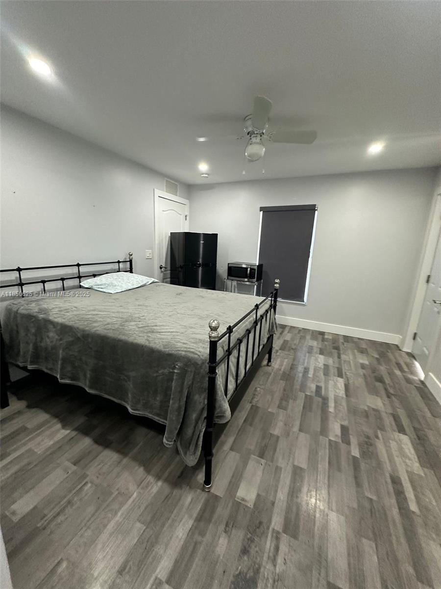 442 Conlee Street Lehigh Acres, FL 33974 - Photo 75 of 79 a bedroom with bed and wooden floor