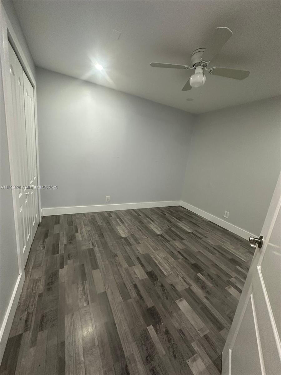 442 Conlee Street Lehigh Acres, FL 33974 - Photo 10 of 79 en empty room with wooden floor