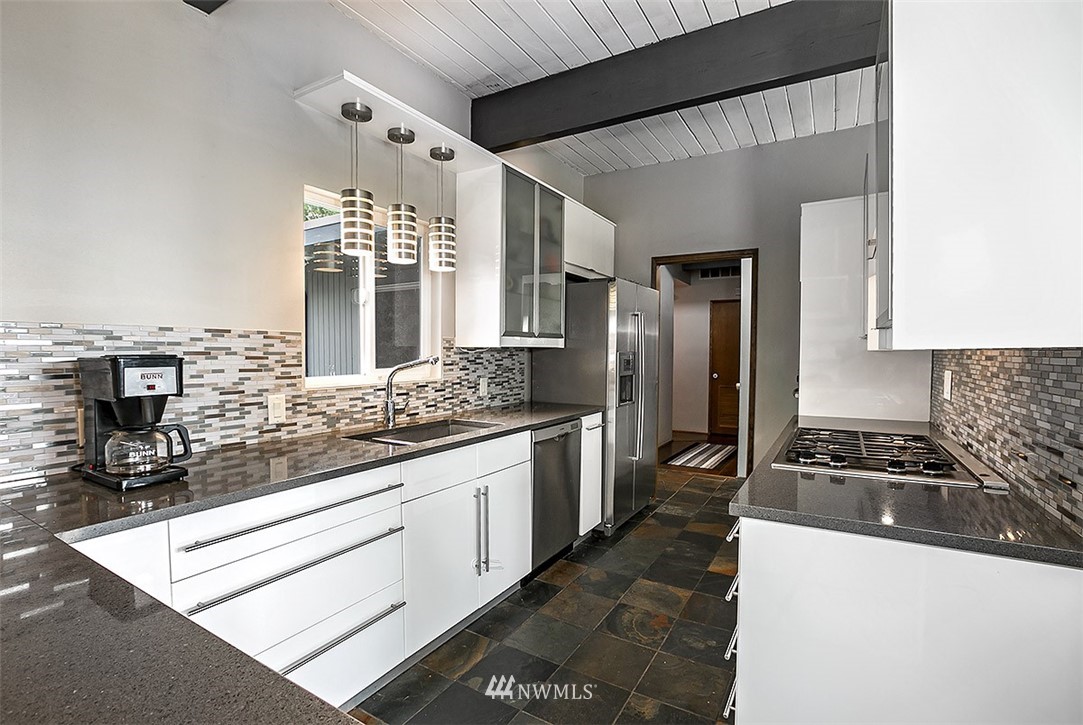 910 High Avenue South Renton, WA 98057 - Photo 14 of 25 a kitchen with stainless steel appliances granite countertop a sink stove and refrigerator