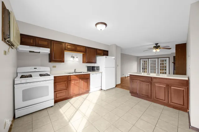 a kitchen with granite countertop a sink stainless steel appliances and cabinets