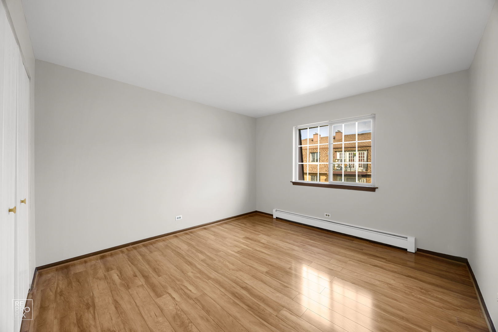 2300 Century Point Lane, Unit F Glendale Heights, IL 60139 - Photo 7 of 10 an empty room with wooden floor and windows