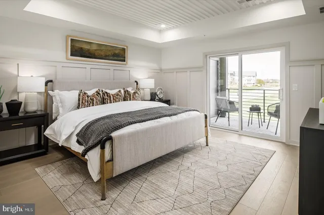 a spacious bedroom with a bed and a large window