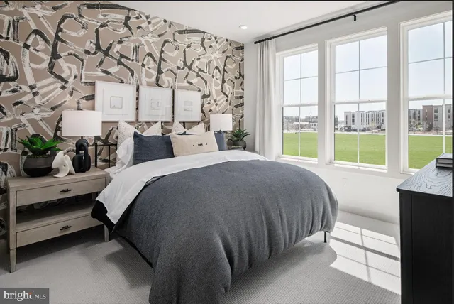 a spacious bedroom with a bed and a large window