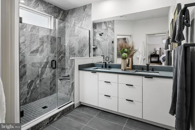 a bathroom with a shower sink and mirror