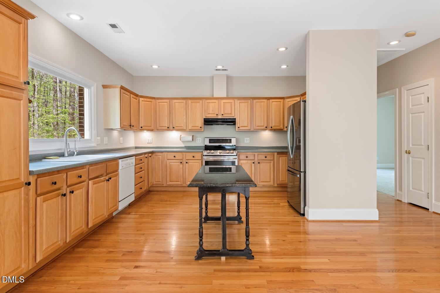 4524 Ridge Trail Efland, NC 27243 - Photo 21 of 48 a kitchen with stainless steel appliances granite countertop a stove a sink and a refrigerator
