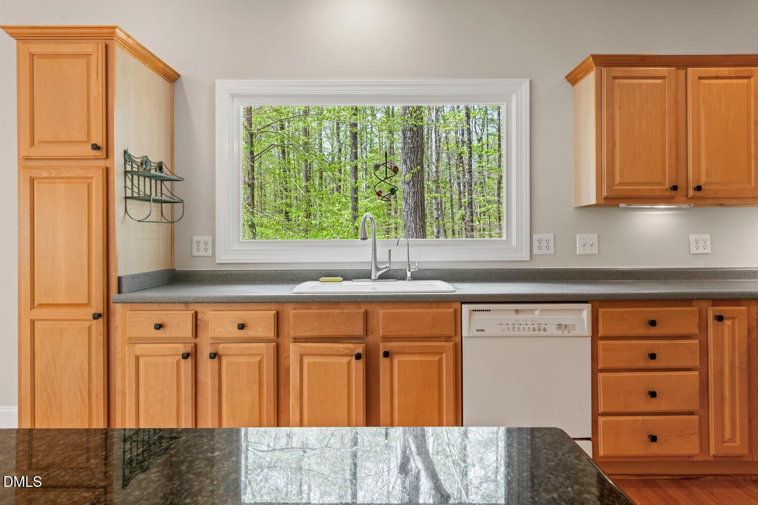 4524 Ridge Trail Efland, NC 27243 - Photo 23 of 48 a kitchen with granite countertop white cabinets and a window