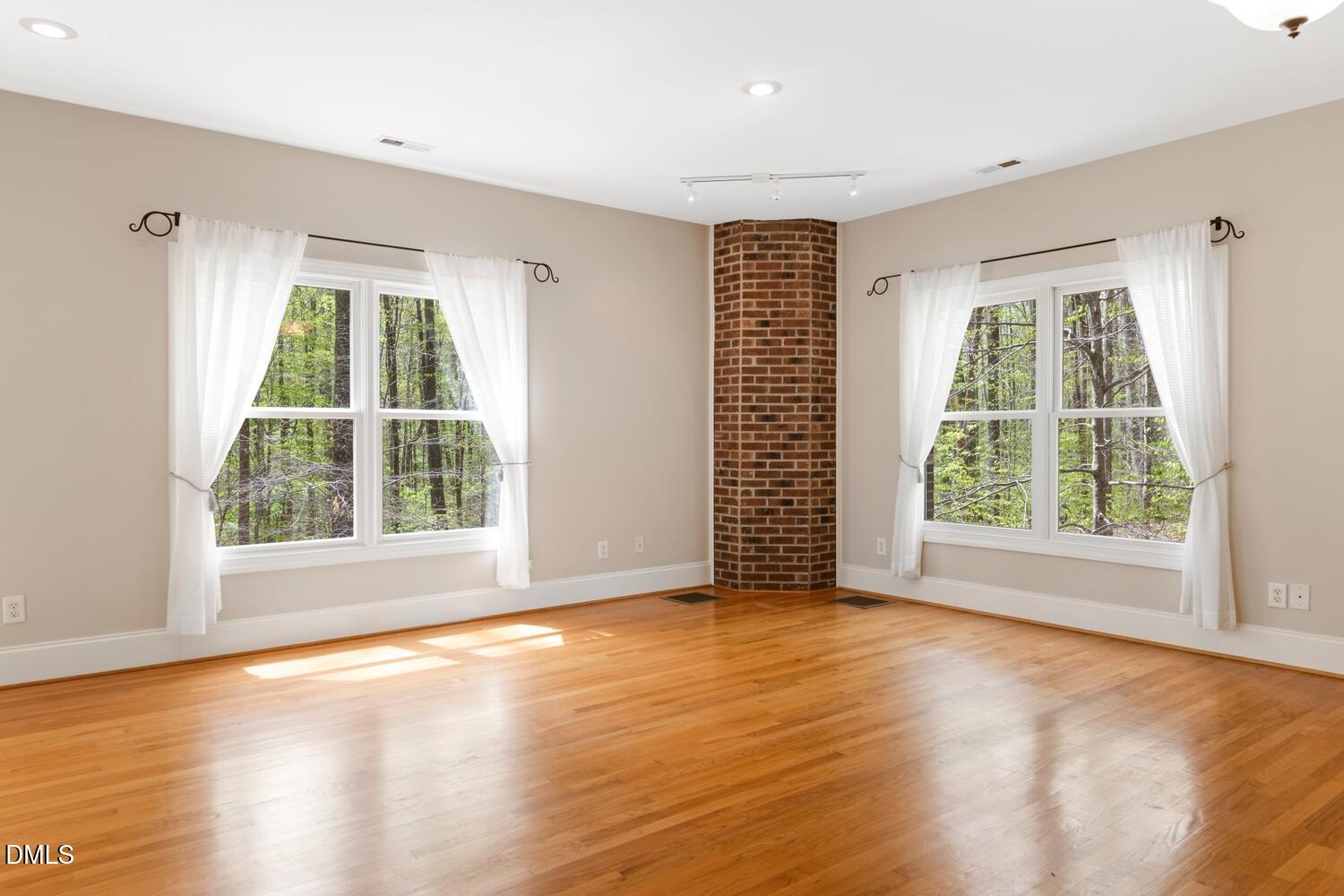 4524 Ridge Trail Efland, NC 27243 - Photo 25 of 48 a view of an empty room with wooden floor and a window