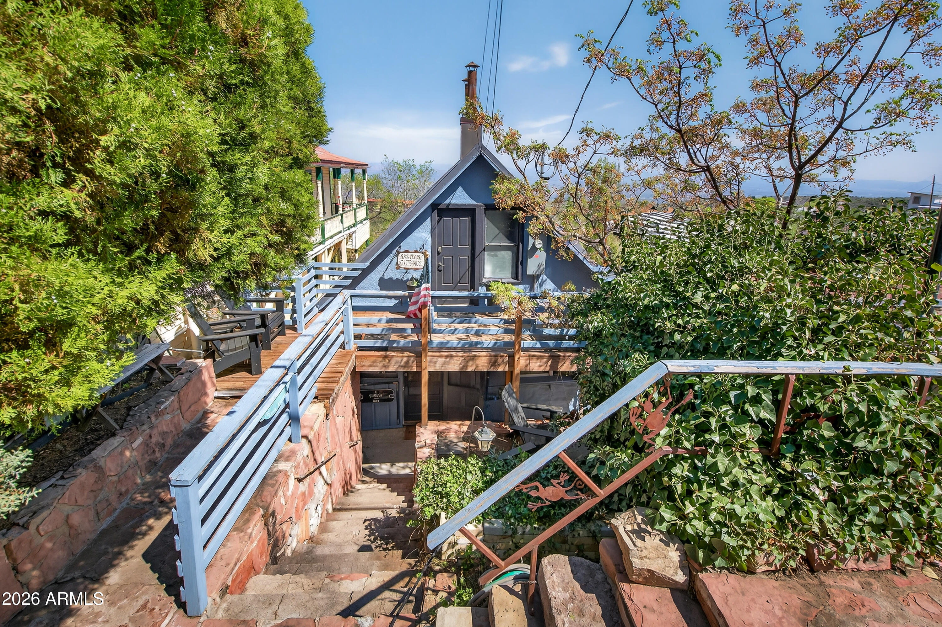 511 Main Street Jerome, AZ 86331 - Photo 45 of 67 a balcony view with two plants and wooden fence