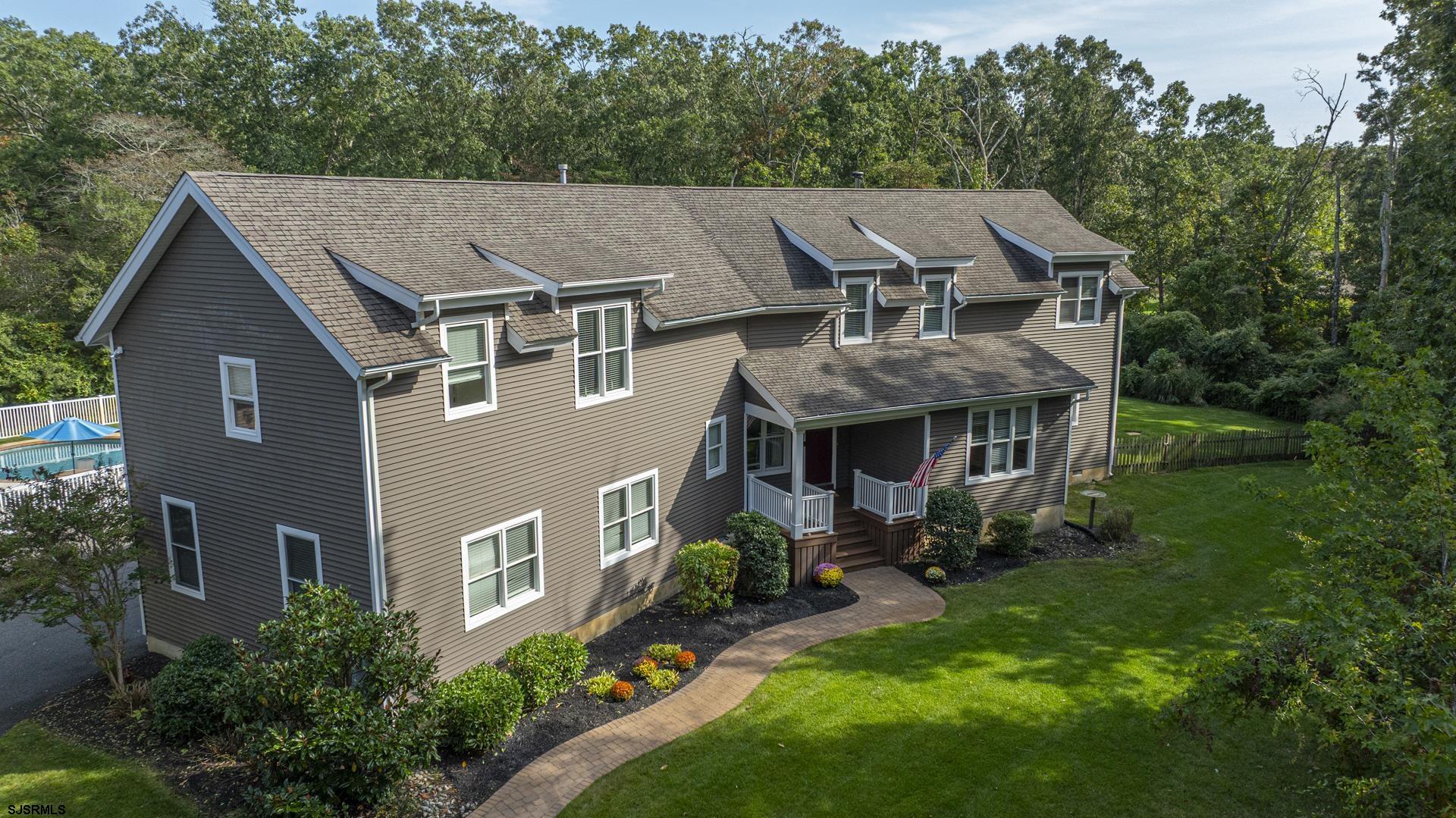 a aerial view of a house next to a yard