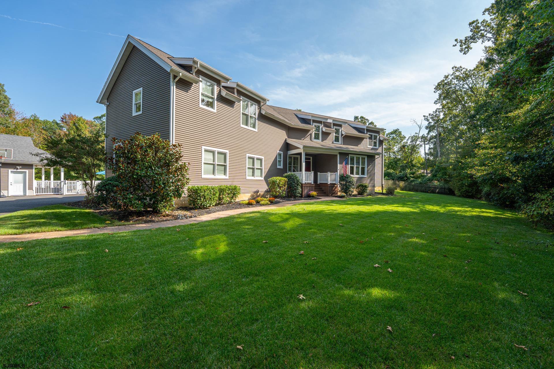 103 Tyler Road Ocean View, NJ 08230 - Photo 2 of 80 a front view of house with yard and green space