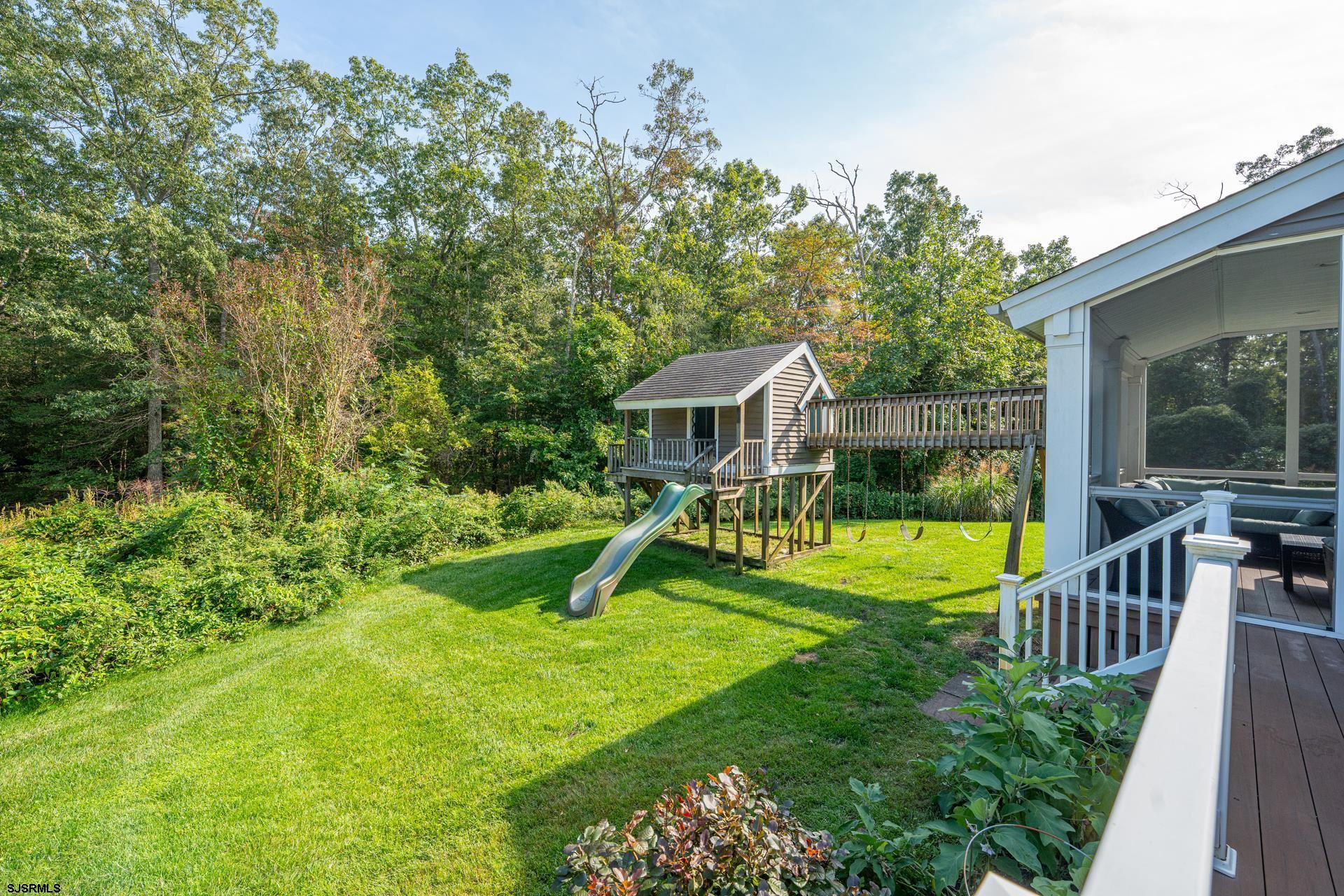 103 Tyler Road Ocean View, NJ 08230 - Photo 25 of 80 a view of a house with a backyard and a tree