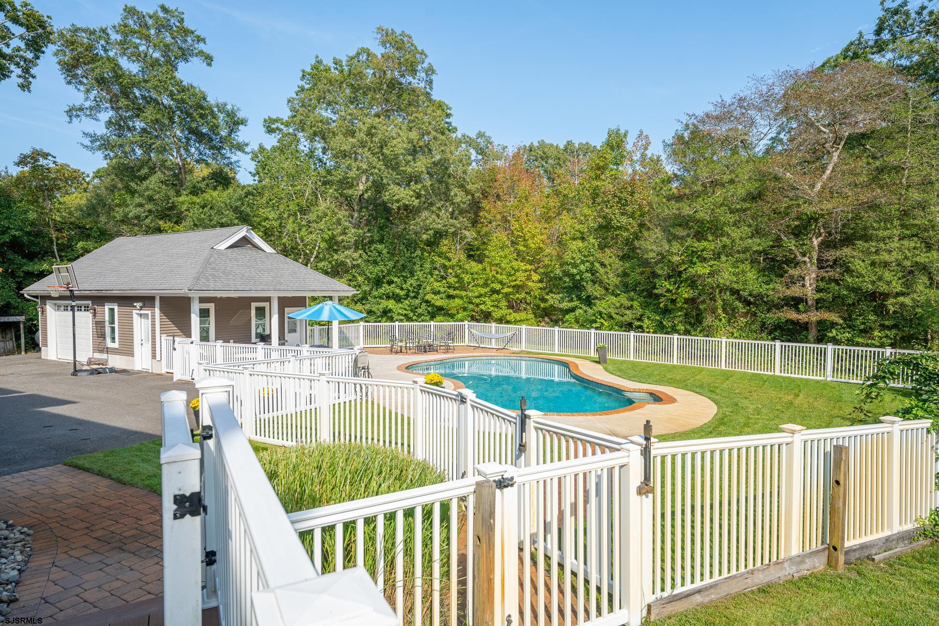 103 Tyler Road Ocean View, NJ 08230 - Photo 26 of 80 a view of a house with wooden deck and a small yard