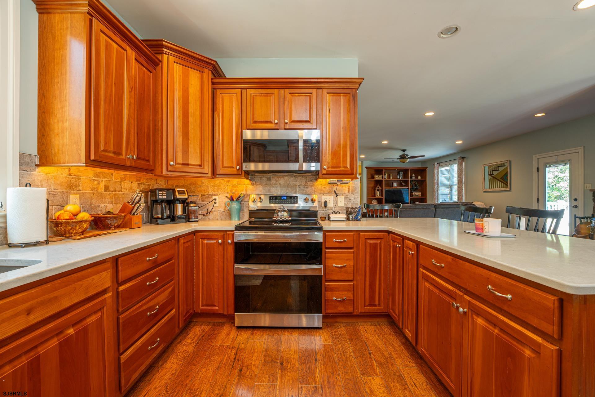 103 Tyler Road Ocean View, NJ 08230 - Photo 45 of 80 a kitchen with stainless steel appliances granite countertop wooden cabinets a sink and a stove