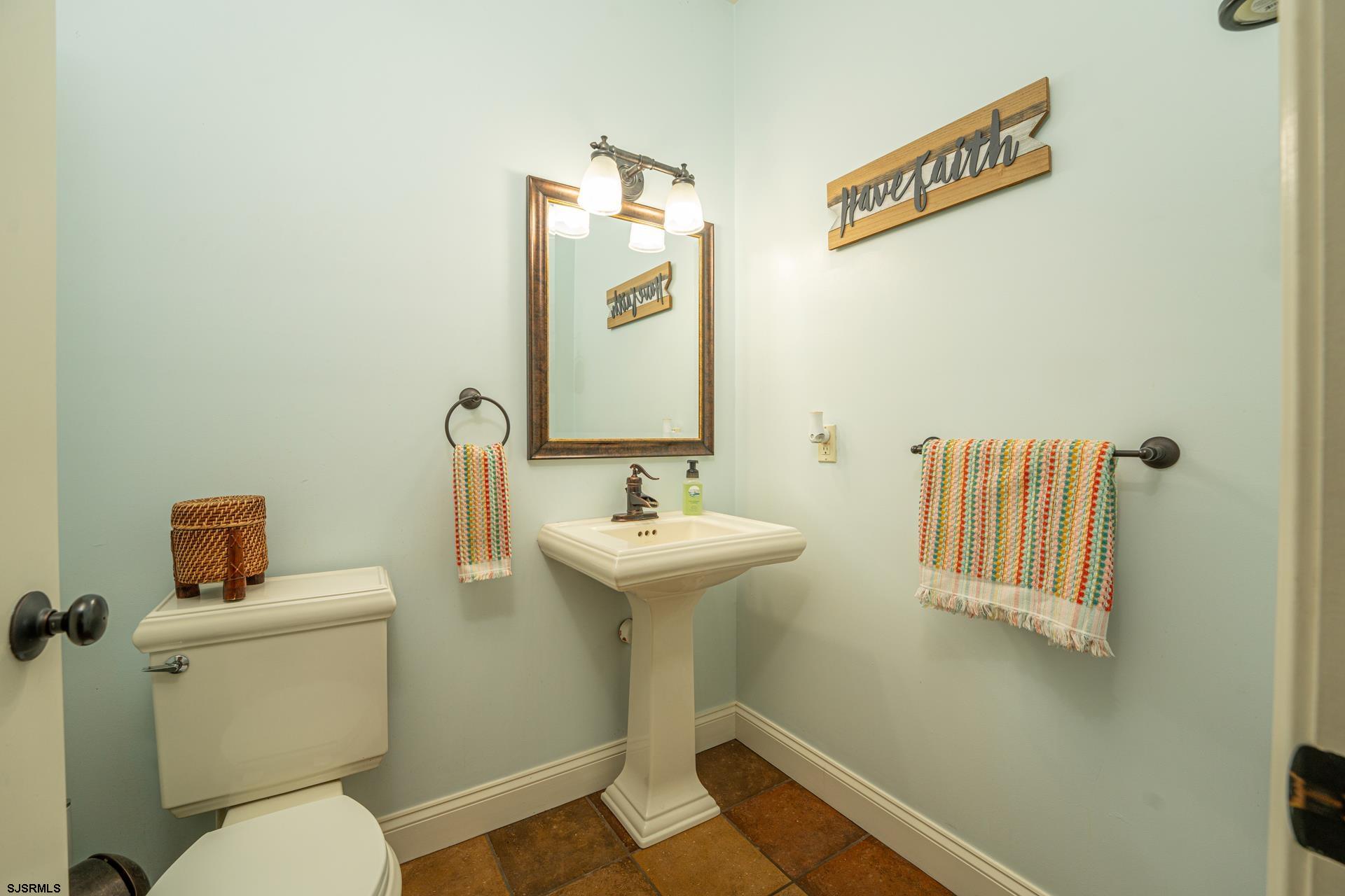 103 Tyler Road Ocean View, NJ 08230 - Photo 55 of 80 a bathroom with a sink a mirror and a toilet