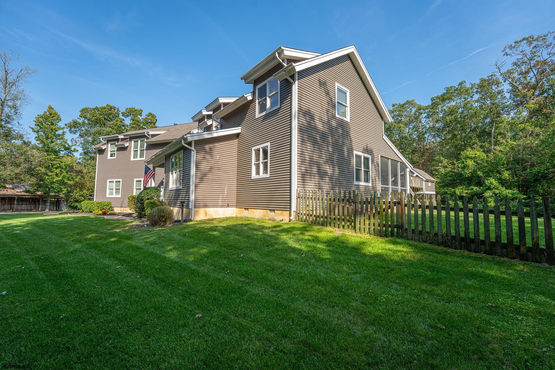 103 Tyler Road Ocean View, NJ 08230 - Photo 6 of 80 a front view of a house with a garden