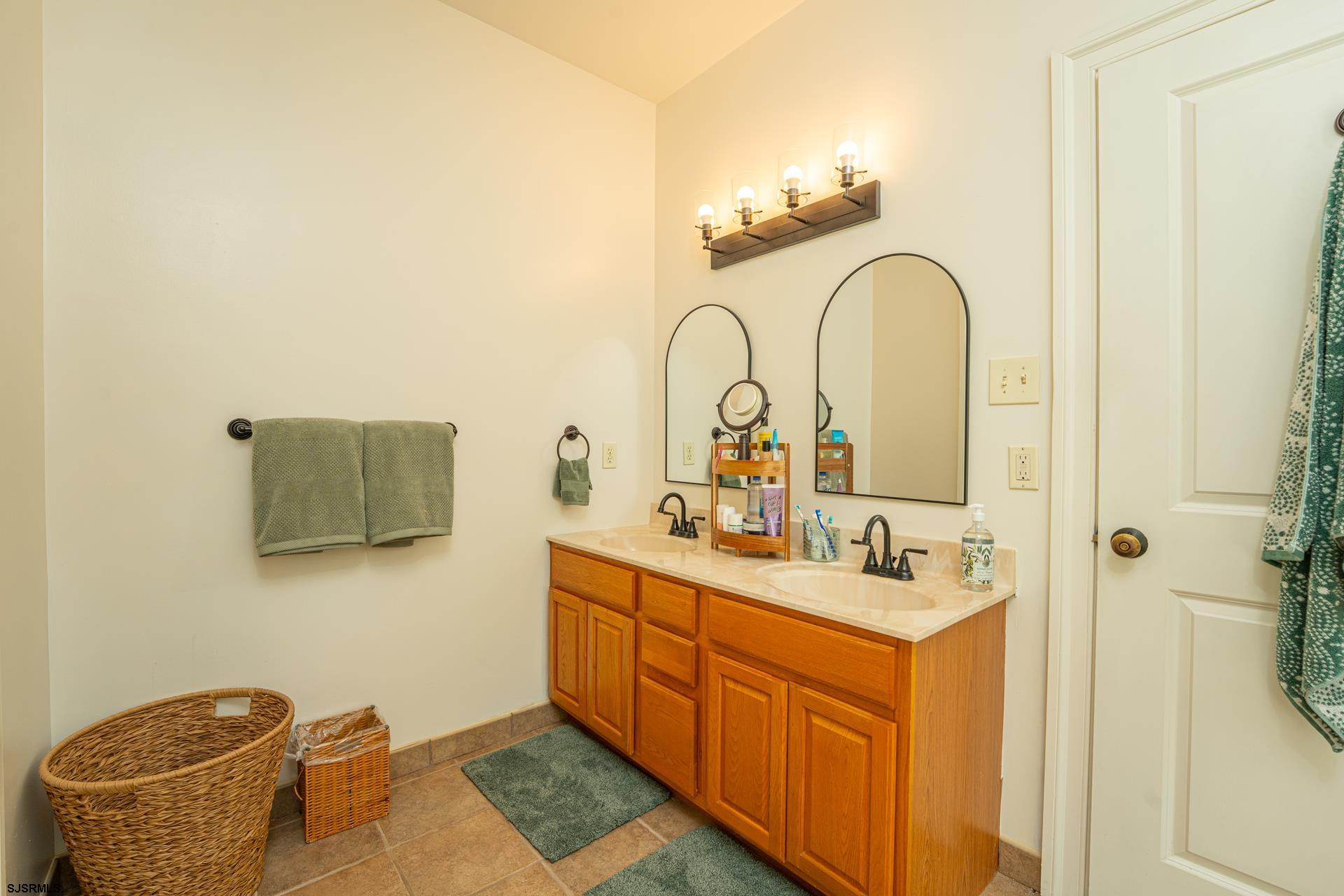 103 Tyler Road Ocean View, NJ 08230 - Photo 63 of 80 a bathroom with a sink and a mirror