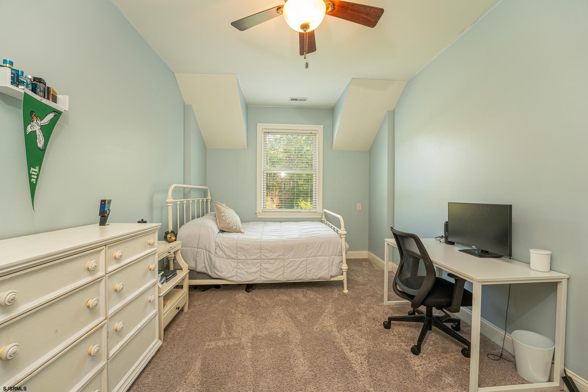 103 Tyler Road Ocean View, NJ 08230 - Photo 65 of 80 a spacious bedroom with a bed and a chandelier
