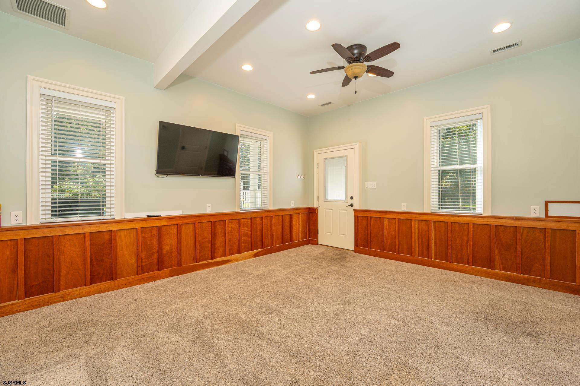 103 Tyler Road Ocean View, NJ 08230 - Photo 76 of 80 an empty room with windows cabinet and a flat screen tv
