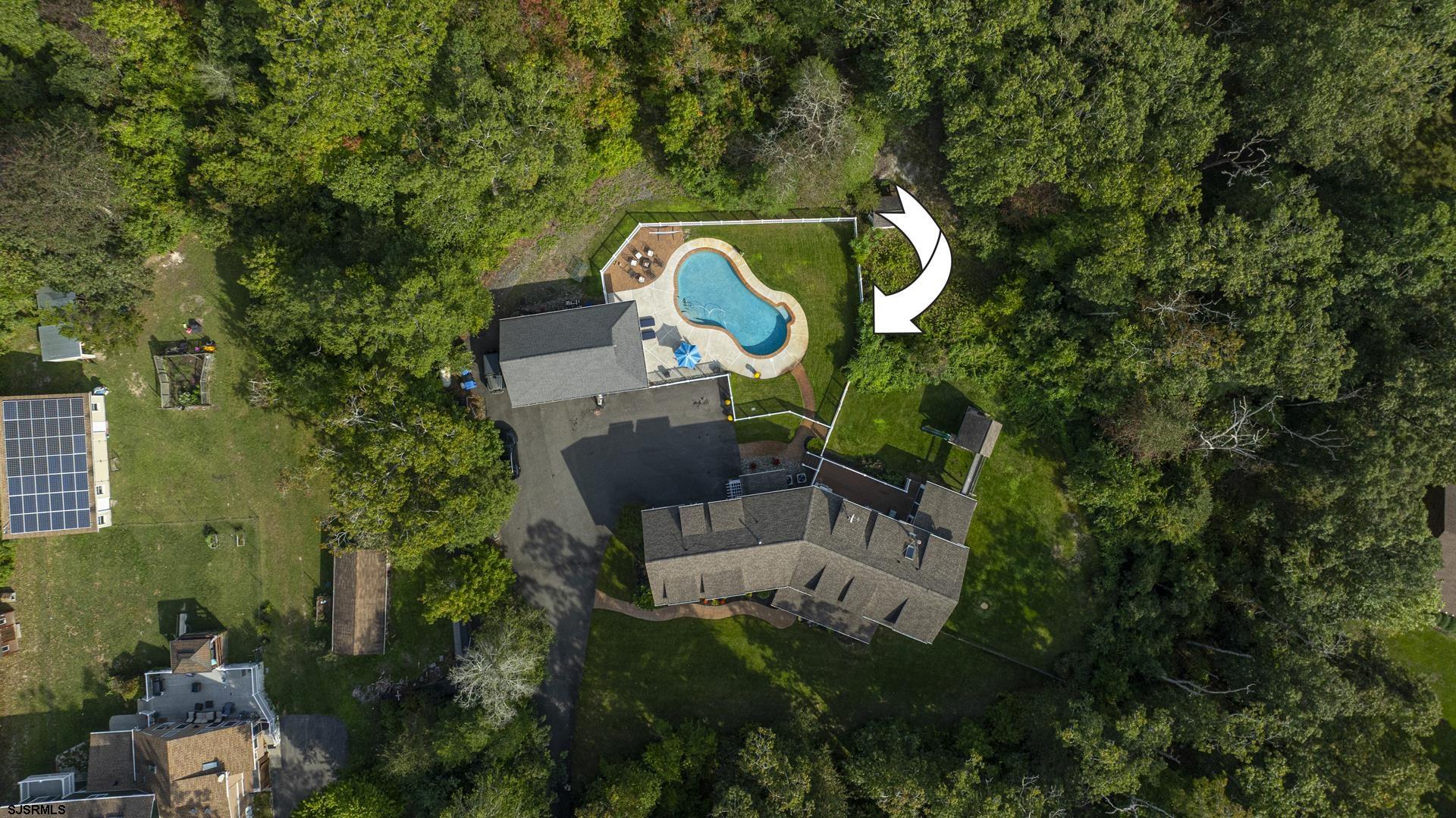 103 Tyler Road Ocean View, NJ 08230 - Photo 79 of 80 an aerial view of a house with a backyard and swimming pool